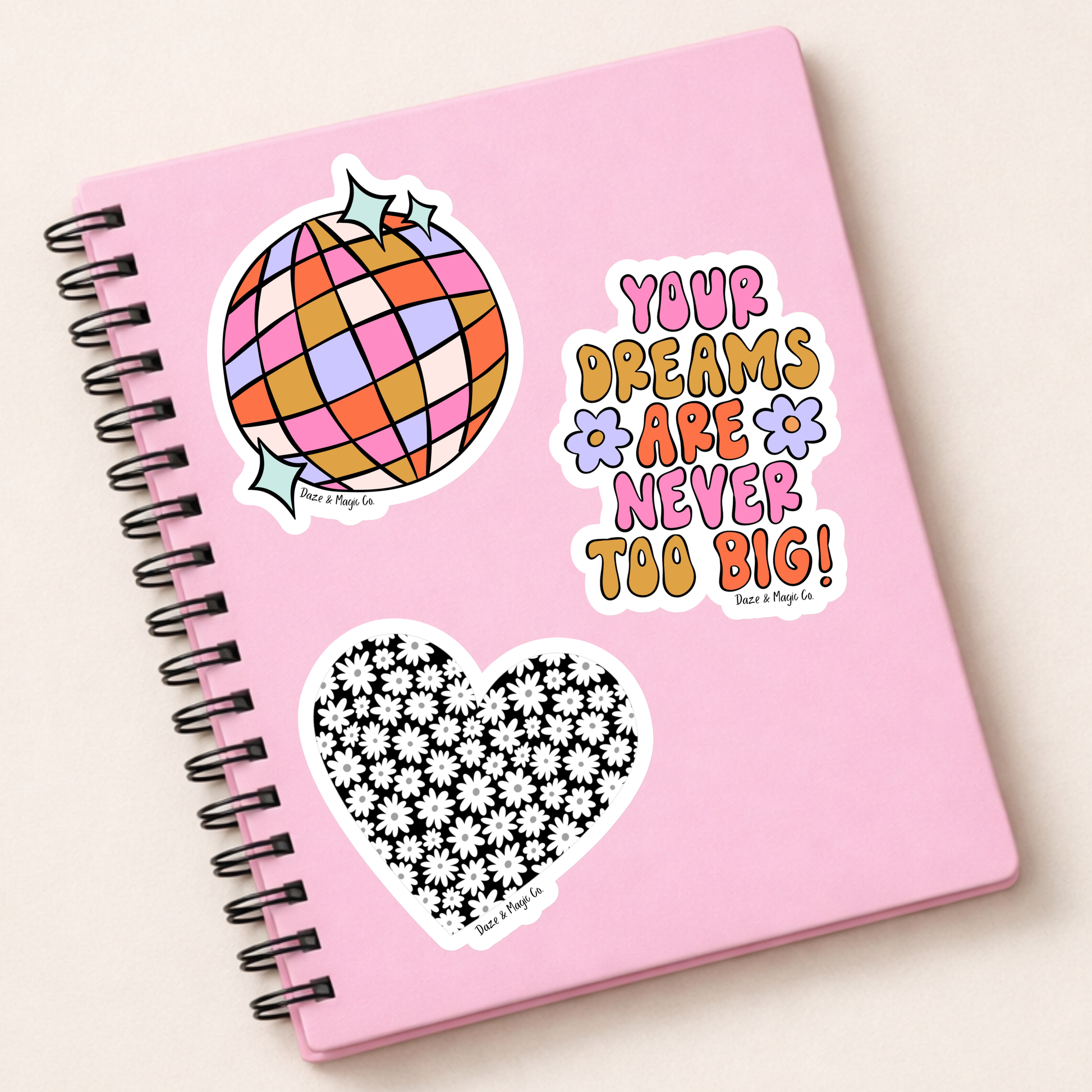 Pink notebook with stickers on a white background