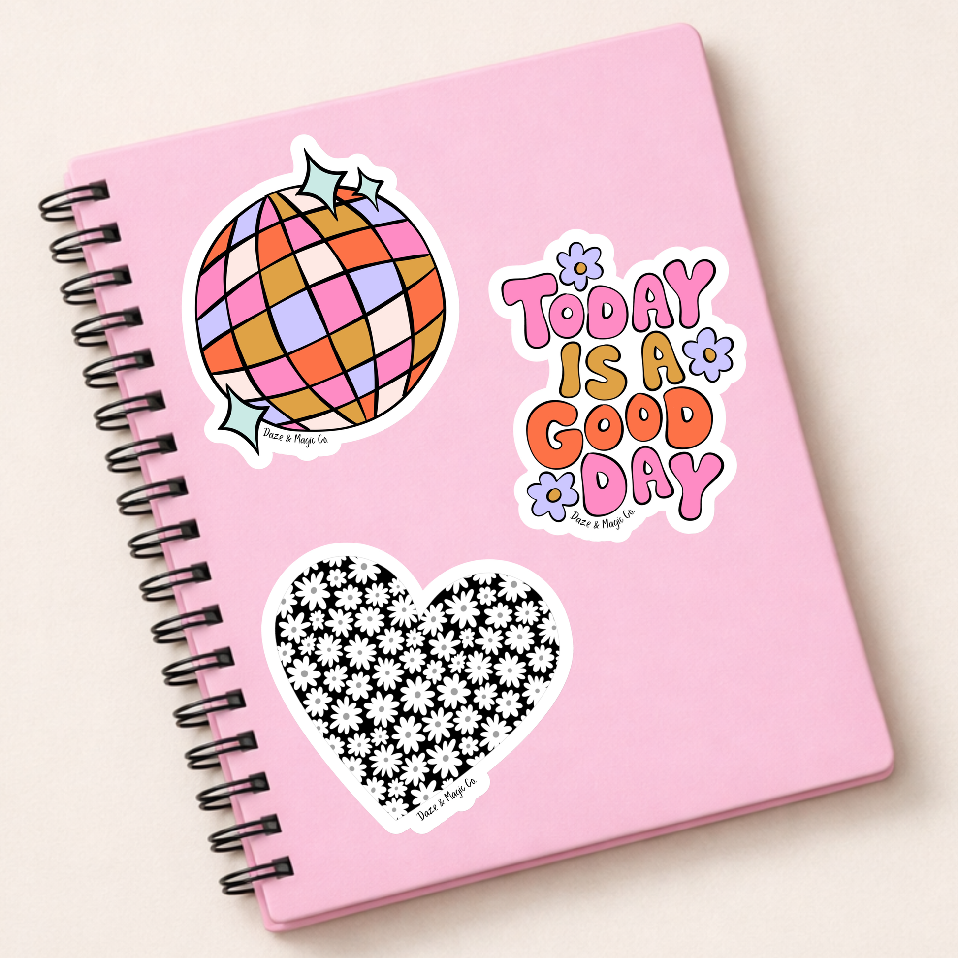 Pink notebook with stickers on a white background