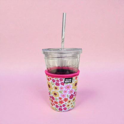 Fall floral iced coffee sleeve in a 16oz on a pink background