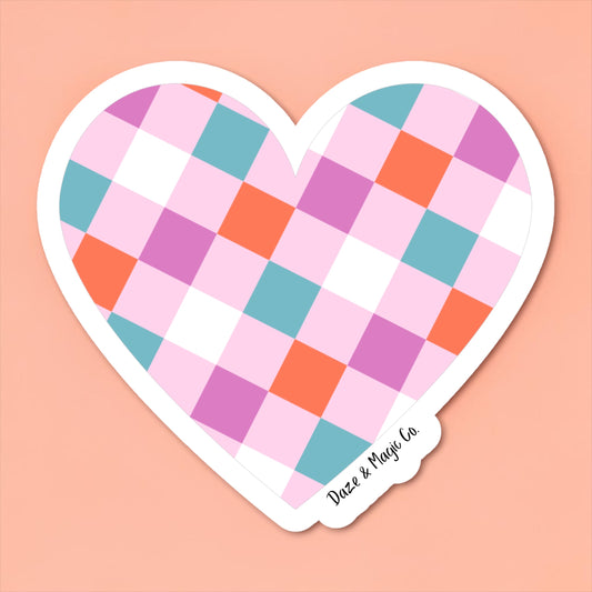 Heart-shaped sticker with a colorful checkered pattern on a pink background