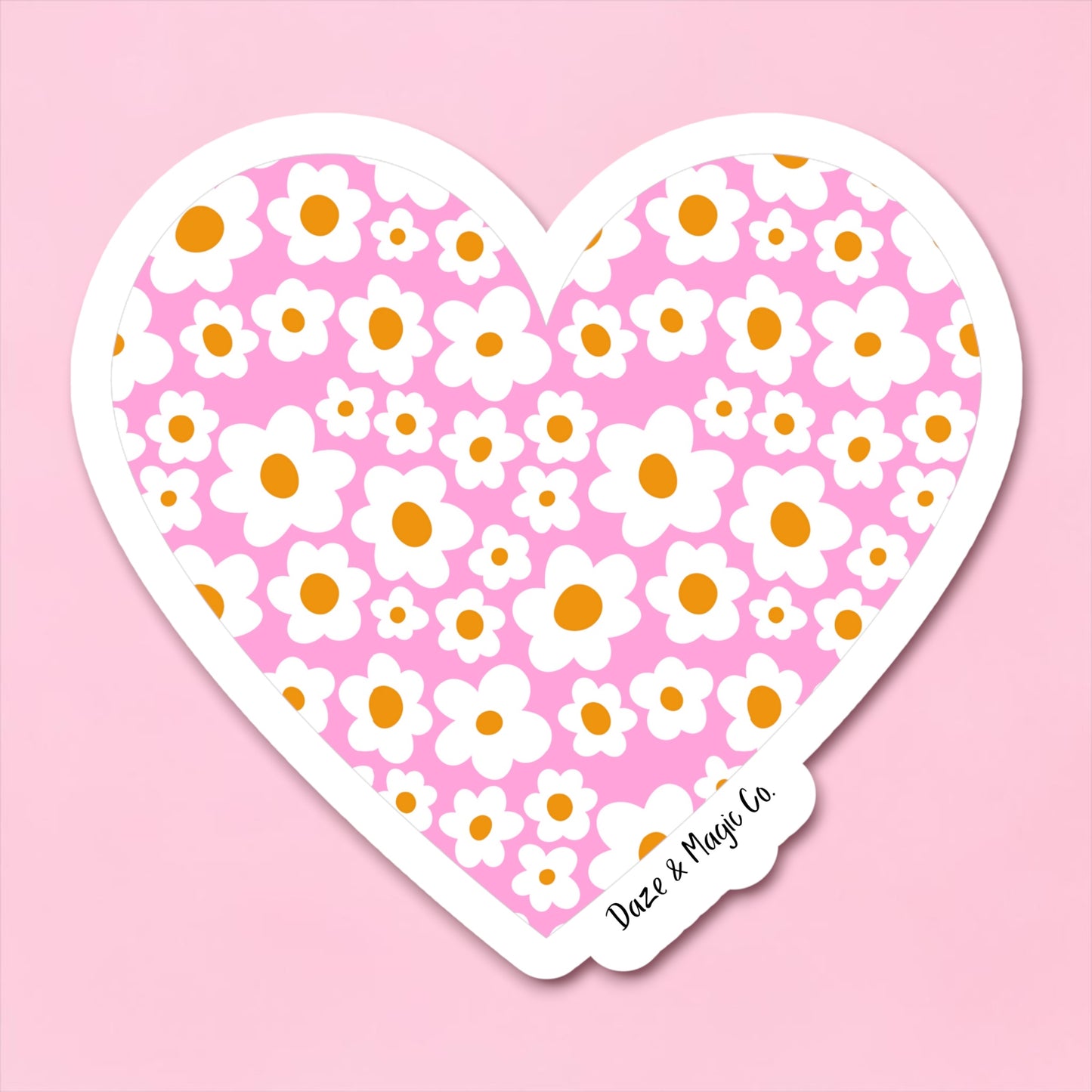 Heart-shaped sticker with floral pattern on a pink background