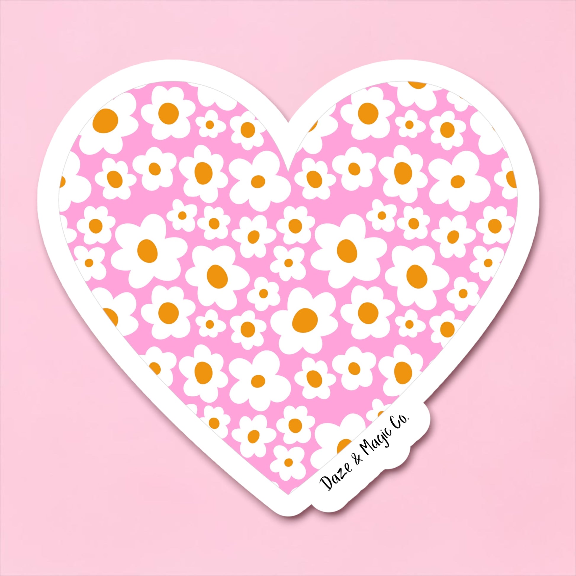 Heart-shaped sticker with floral pattern on a pink background
