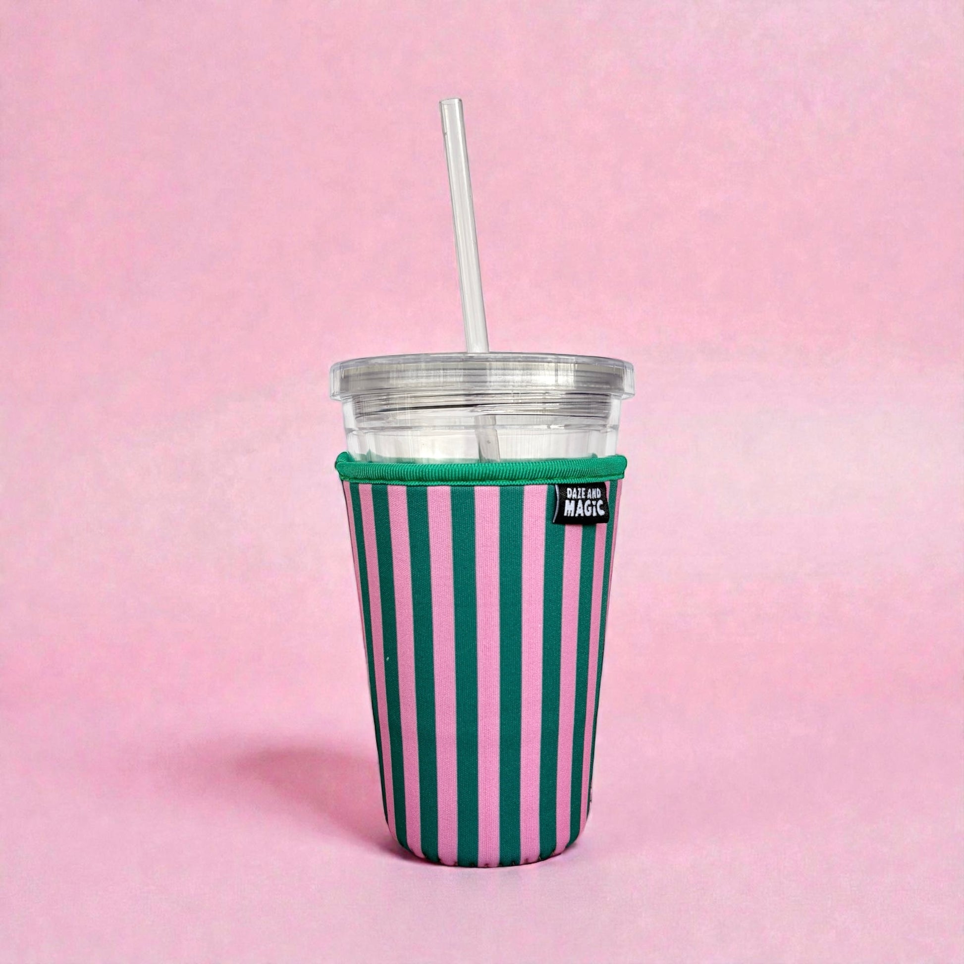 Pink and green striped 24oz neoprene iced coffee sleeve on clear plastic cup