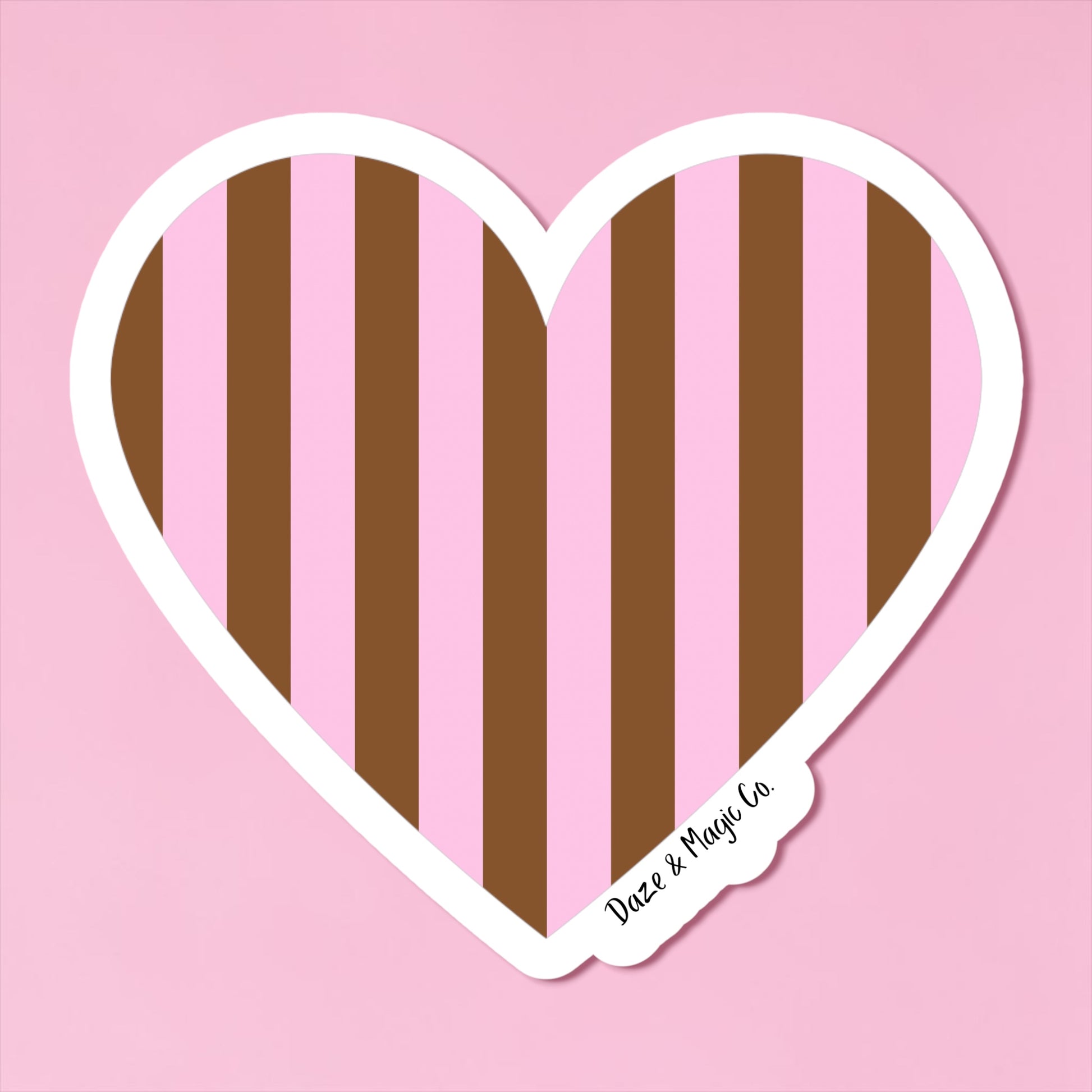 Heart-shaped sticker with brown and pink vertical stripes on a pink background