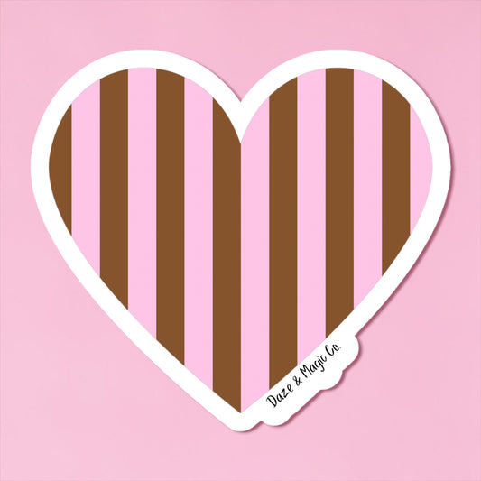 Heart-shaped sticker with brown and pink vertical stripes on a pink background