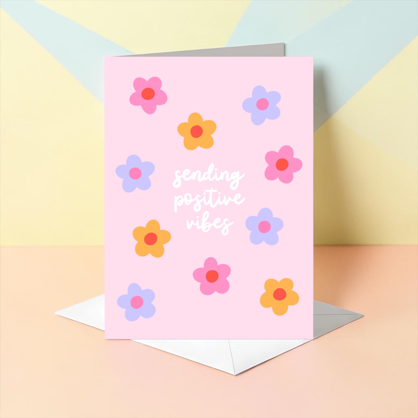Card with colorful flowers and 'sending positive vibes' text on a pastel background