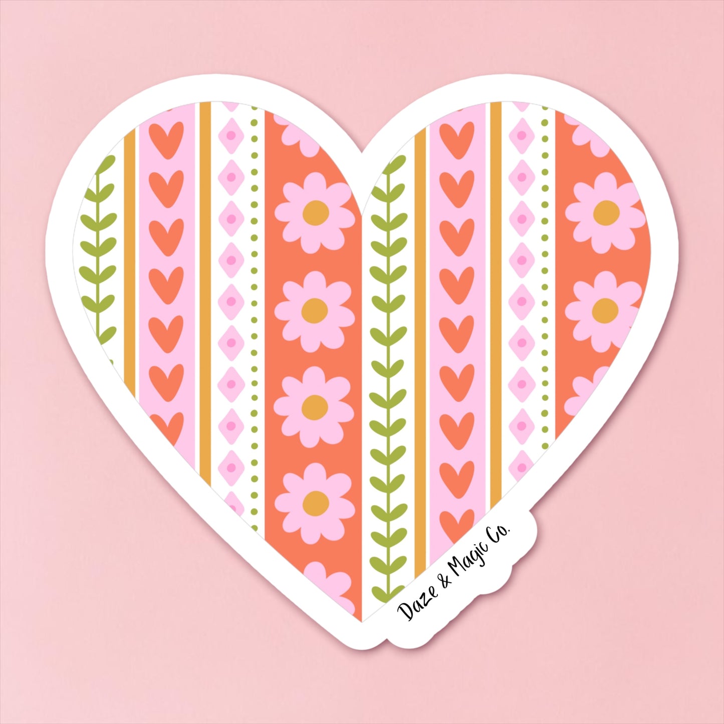 Heart-shaped sticker with floral and striped design on a pink background