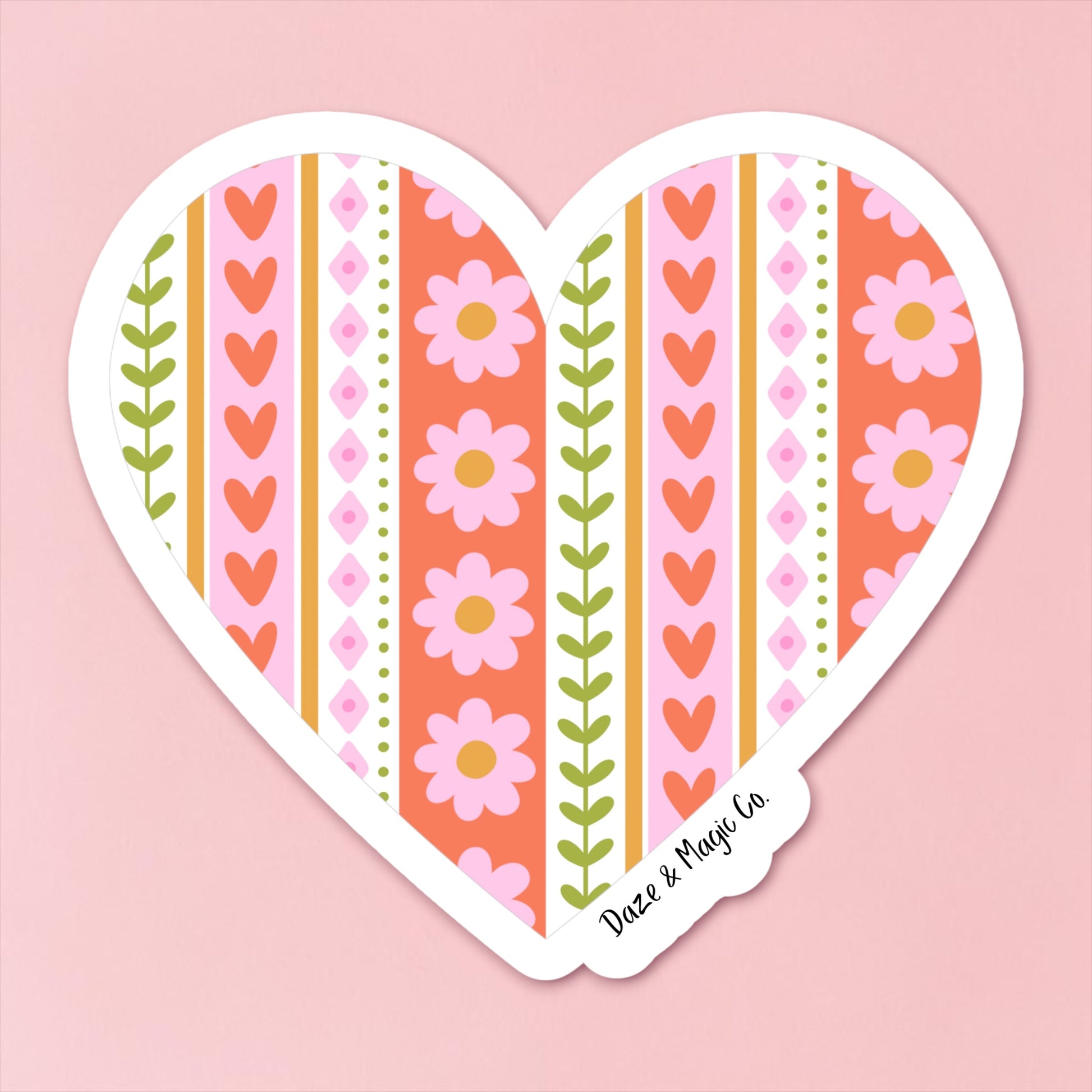 Heart-shaped sticker with floral and striped design on a pink background