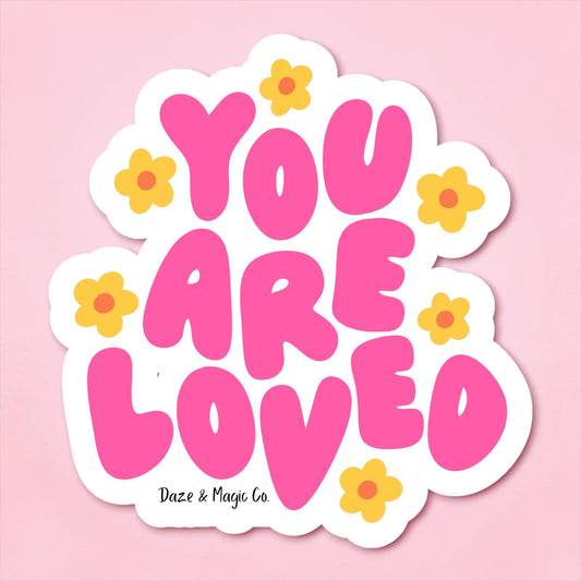 Sticker with 'YOU ARE LOVED' text on a pink background with flowers